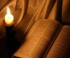 La Bibbia e una candela accesa su l'altare