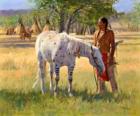 Indiano guerriero con il suo cavallo presso il campo