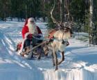 Babbo Natale in slitta con le renne sulla neve