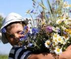 Un bambino con un dono per sua madre, un gran mazzo di fiori